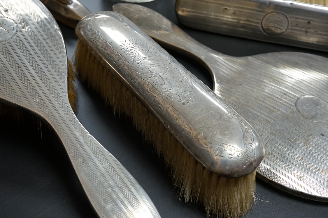 Ten assorted silver mounted dressing table items, including brushes, hand mirror, manicure items and glove stretchers.